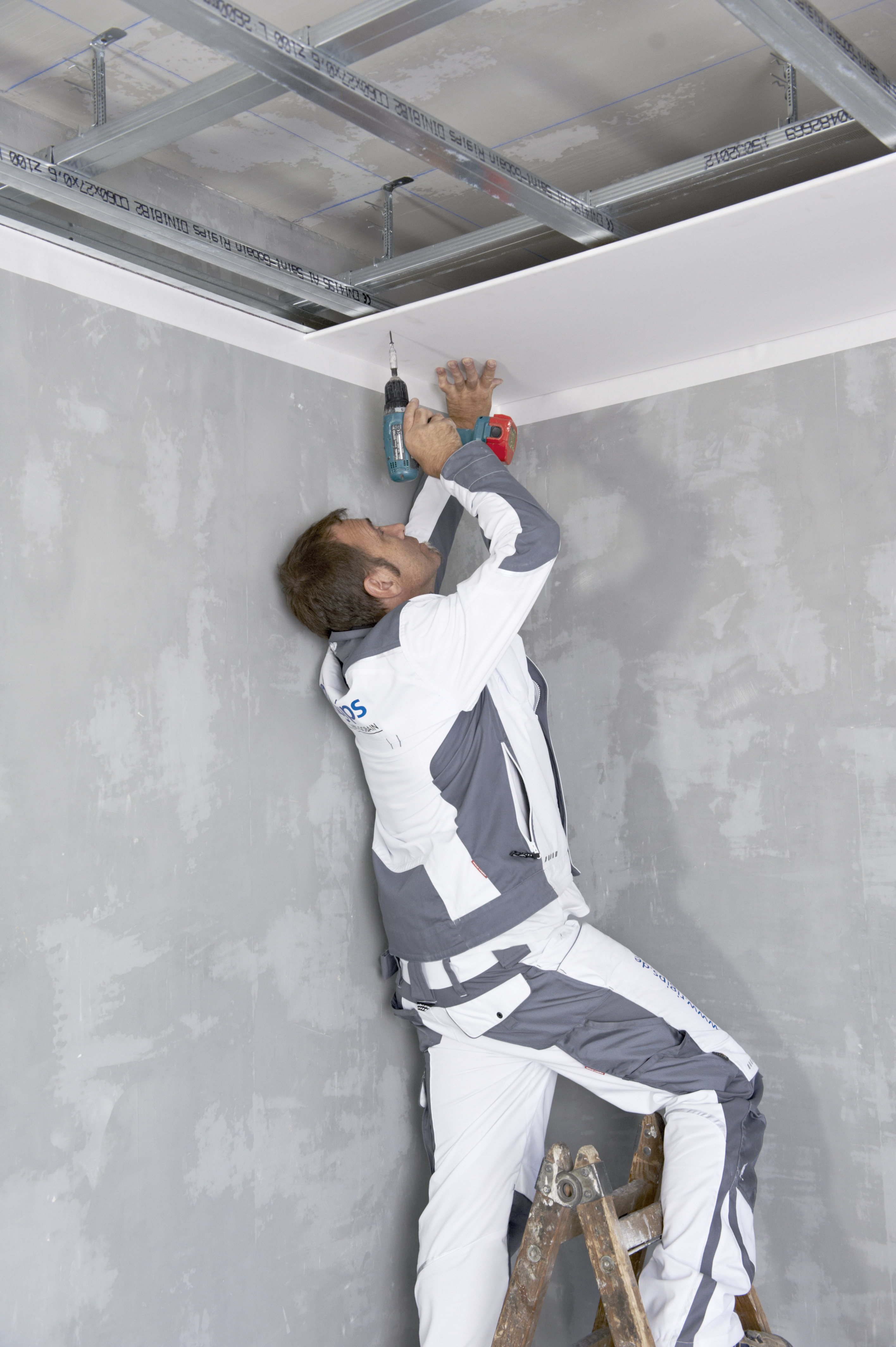 A handyman installing the ceiling